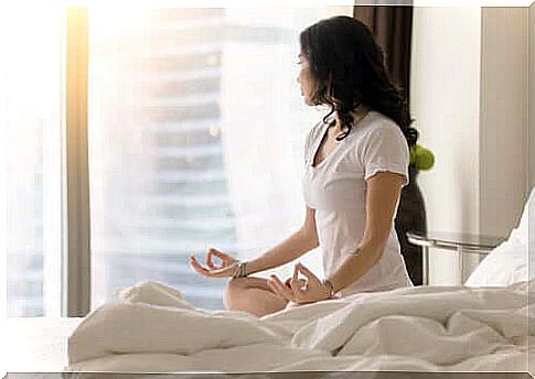 Woman meditating in bed