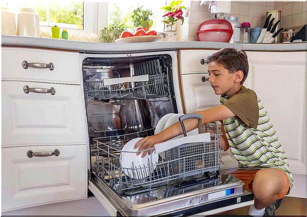 Chores like emptying the dishwasher can help kids develop responsibility