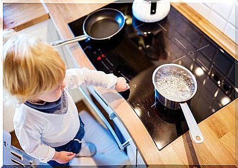 Child with a pan of boiling water